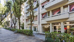 A multi-story building with a Canon store on the ground floor. - Studio Piccolo a Carignano by Wonderful Italy (Genoa)