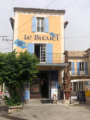 A two-story building with the sign 'Le Bleuet' and a blue flower motif. - The Gavottes (Revest-des-Brousses)