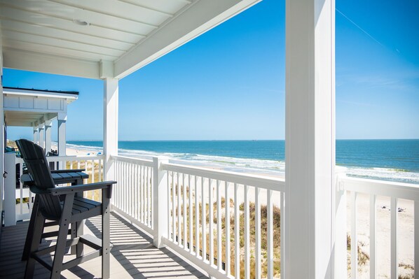 A wooden deck with a view of the ocean.