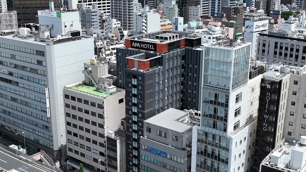 A high-rise hotel with multiple floors, a prominent sign, and a modern architectural design. - APA Hotel Ueno Ekimae (Tokyo)