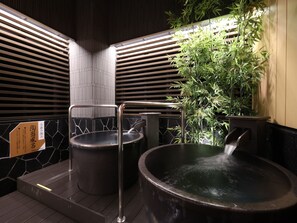 A traditional Japanese onsen with two hot tubs, bamboo plants, and wooden slats. - APA Hotel Ueno Ekimae (Tokyo)