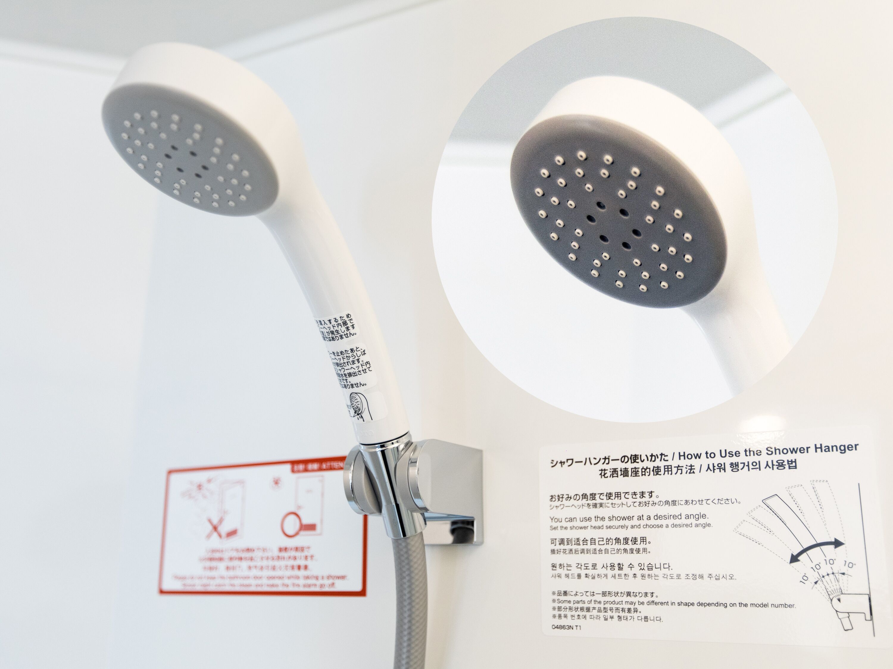 A shower head with a flexible hose and a control panel.