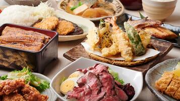 A variety of Japanese dishes including sushi, tempura, and beef.