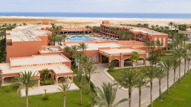 A resort with a pool, palm trees, and a beach view. - JAZ Tamerina, Almaza Bay (Marsa Matrouh)