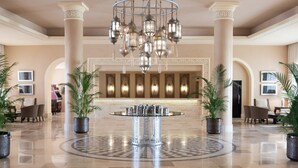 A spacious lobby with a central round table, ornate columns, and a decorative chandelier. - JAZ Tamerina, Almaza Bay (Marsa Matrouh)