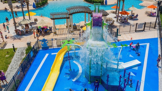 A water park with multiple slides and a central water feature. - Windsor Oasis 6BR Pool & Game Room  9 min Disney! (Kissimmee)