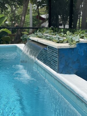A swimming pool with a water feature.