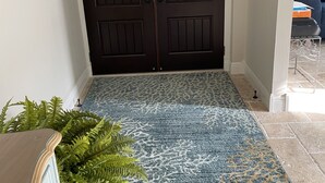 A dark wooden double door with a textured mat in front. - Love Water? Gulf Access, Boat Dock, Private Heated Pool in Lanai. (Cape Coral)