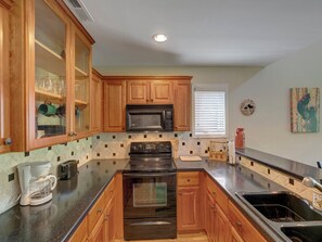 Dishwasher, coffee/tea maker, cookware/dishes/utensils, dining tables