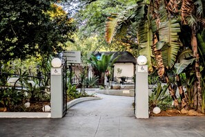 A pathway leading to a building with a sign indicating a restaurant and reception area.
