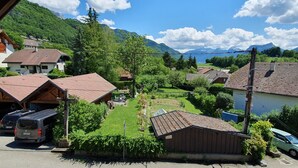 A residential area with houses, a parked van, and a river. - Le Typique Atypique Spacieux 140 m2 au Centre du Hameau de Perroix (talloires montmin)