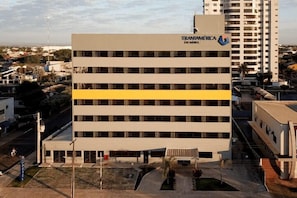 A multi-story building with a flat facade, a prominent yellow stripe, and the name 'Transamerica' on the top.