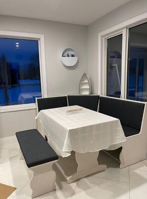 Meet and work in style with a compact room featuring a dedicated workspace, comfortable seating, and a large window offering a view of the outdoors.