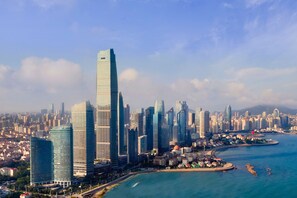 A cityscape with modern skyscrapers and a waterfront. - The St. Regis Qingdao (Qingdao)