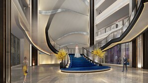 A modern interior with a central blue staircase, a curved ceiling, and a glass elevator. - The St. Regis Qingdao (Qingdao)