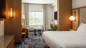 A hotel room with a bed, a desk, a chair, a TV, and a window with curtains. - Fairfield Inn & Suites by Marriott Knoxville Northwest (Knoxville)