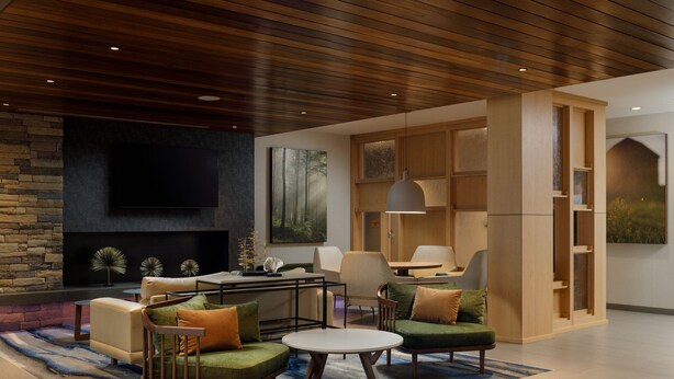 A modern living room with a stone fireplace, comfortable seating, and a large flat-screen TV. - Fairfield Inn & Suites by Marriott Knoxville Northwest (Knoxville)