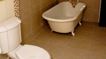 Bathtub, towels, soap, toilet paper