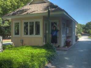 A small, single-story house with a front porch, a window, and a door. - Beautiful Emerald Isle Ocean Side Home, Steps from the Beach (Emerald Isle)