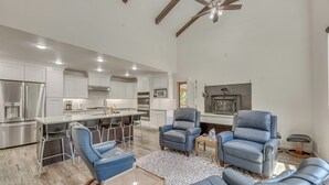 A spacious kitchen with modern appliances, a dining area with bar stools, and a seating area with leather chairs. - Modern Alpine Cabin 3 Miles to Ski Cloudcroft (Cloudcroft)