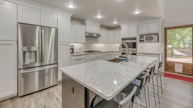 A modern kitchen with white cabinetry, stainless steel appliances, and a marble countertop. - Modern Alpine Cabin 3 Miles to Ski Cloudcroft (Cloudcroft)