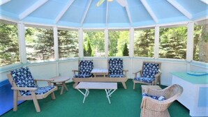 A covered patio with seating, a ceiling fan, and a view of trees. - RUSH SALE- Family Discount! Weeks of Aug 22-Sept 5th!!! (Dennis)