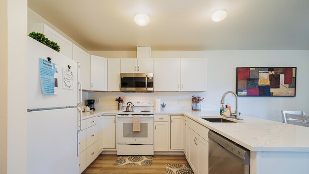 A modern kitchen with white cabinets, stainless steel appliances, and a marble countertop. - Wander in to Alpine, a basecamp for your adventure!! (Leavenworth)