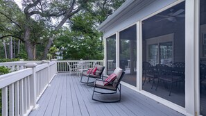 Relax on the covered deck with a view of the interior dining area.