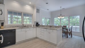 Enjoy cooking in this well-equipped kitchen with a dishwasher and dining area.