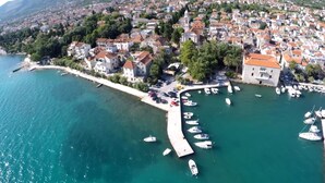 An aerial view of a coastal town with a marina, buildings, and a clear blue sea. - Spacious apt With Lodge Just 40m From the Beach (Kastela)
