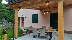 An outdoor patio with a wooden pergola, wicker chairs, and a table. - Spacious Apartment w Patio 40m From the Beach (Kastela)