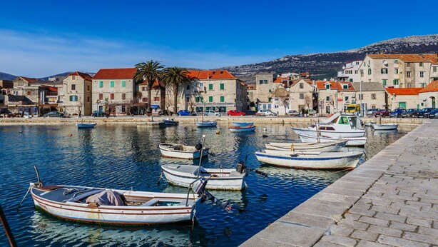 A waterfront with boats docked and buildings along the shore. - Seafront Spacious Apt, 120 m2 Size, in the Center (Kastela)