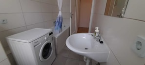 Bathtub, hair dryer, towels, soap
