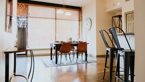A dining area with a table, chairs, a clock, and a window with blinds. - Stunning townhouse on quiet street in Springfield! (Jacksonville)
