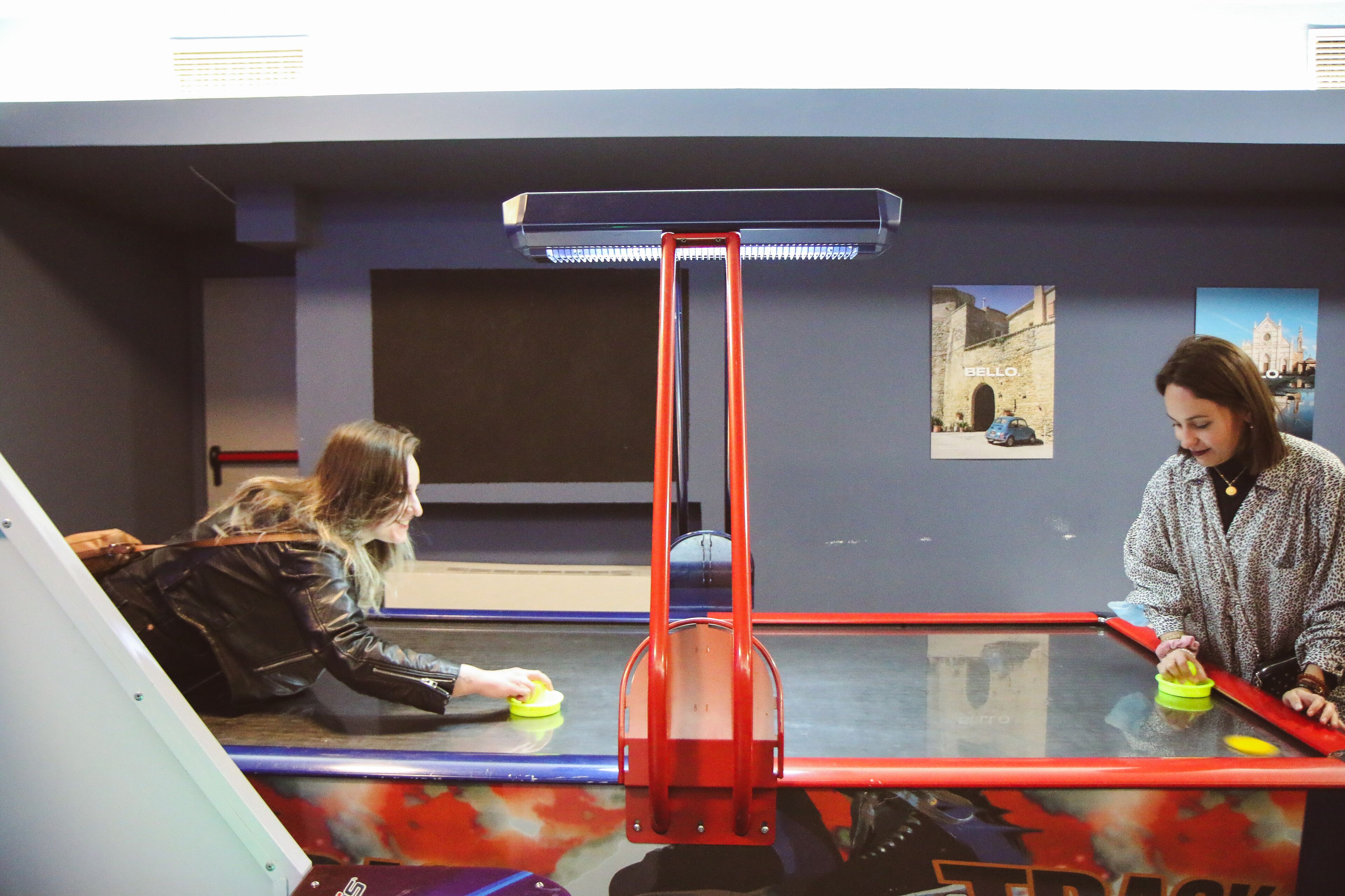 A room with a table, chairs, and a red object in the center.