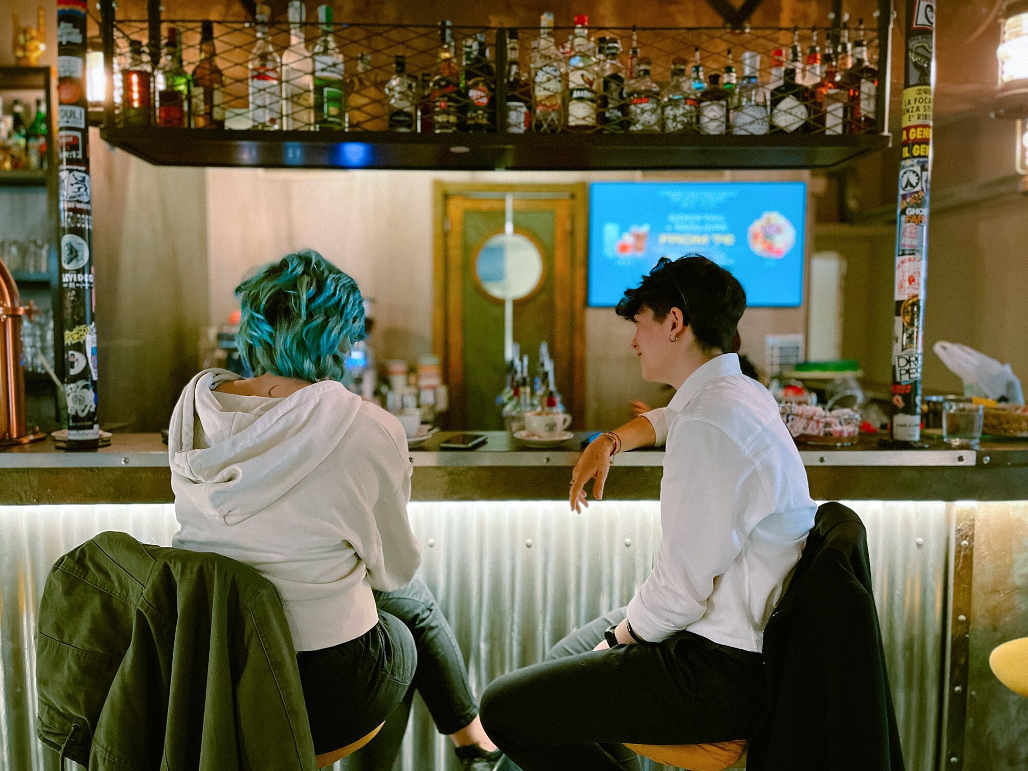 A bar area with a counter and various bottles.