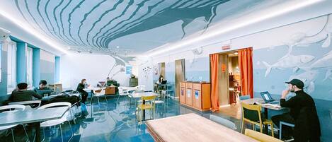 A modern interior with a unique ceiling design, a bar area, and seating arrangements.