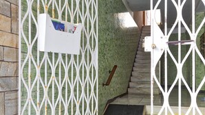 A gated entrance with a metal gate, a staircase, and a small mat at the base. - A due passi dal Porto di Santa Margherita Ligure by Wonderful Italy (Santa Margherita Ligure)