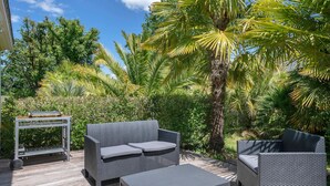 An outdoor patio with wicker furniture, a small table, and a roll of paper towels. - Superb house for 8 in Crach with swimming pool (Crach)