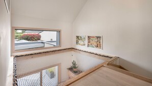 A modern interior with a sloped ceiling, a view through a window, and artwork on the walls. - Bright house with large terrace in La Roche-Bernard (La Roche-Bernard)