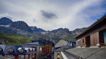 A mountain town with buildings and a view of snow-capped mountains.