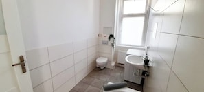 Bathtub, towels, soap, toilet paper