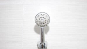 A showerhead mounted on a wall.