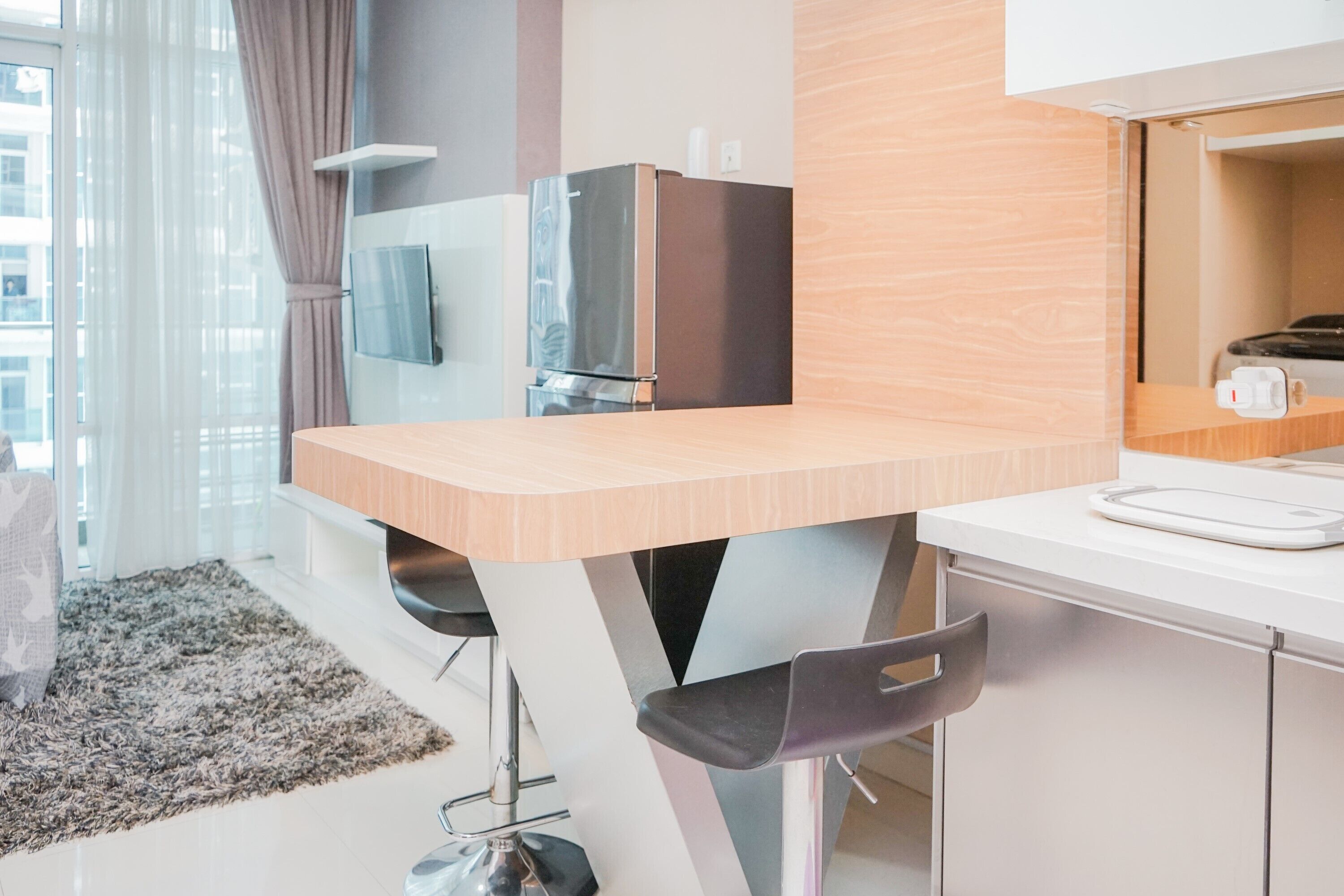 A modern kitchen with a wooden countertop, stainless steel appliances, and a built-in oven.