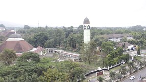 A large building with a prominent tower and a dome.