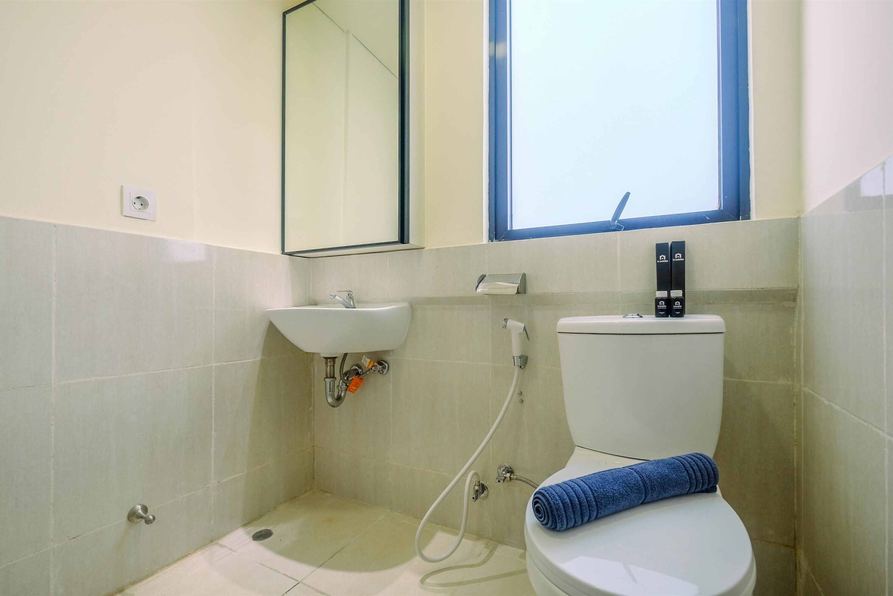 A bathroom with a toilet, sink, and shower.