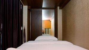 A hotel room with a bed, a door leading to another room, and a curtain. - Simply and Cozy Studio at Dave Apartment (Depok)