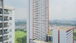 A high-rise building with multiple floors, large windows, and a flat roof. - Wonderful 1BR at Silkwood Apartment (Tangerang)
