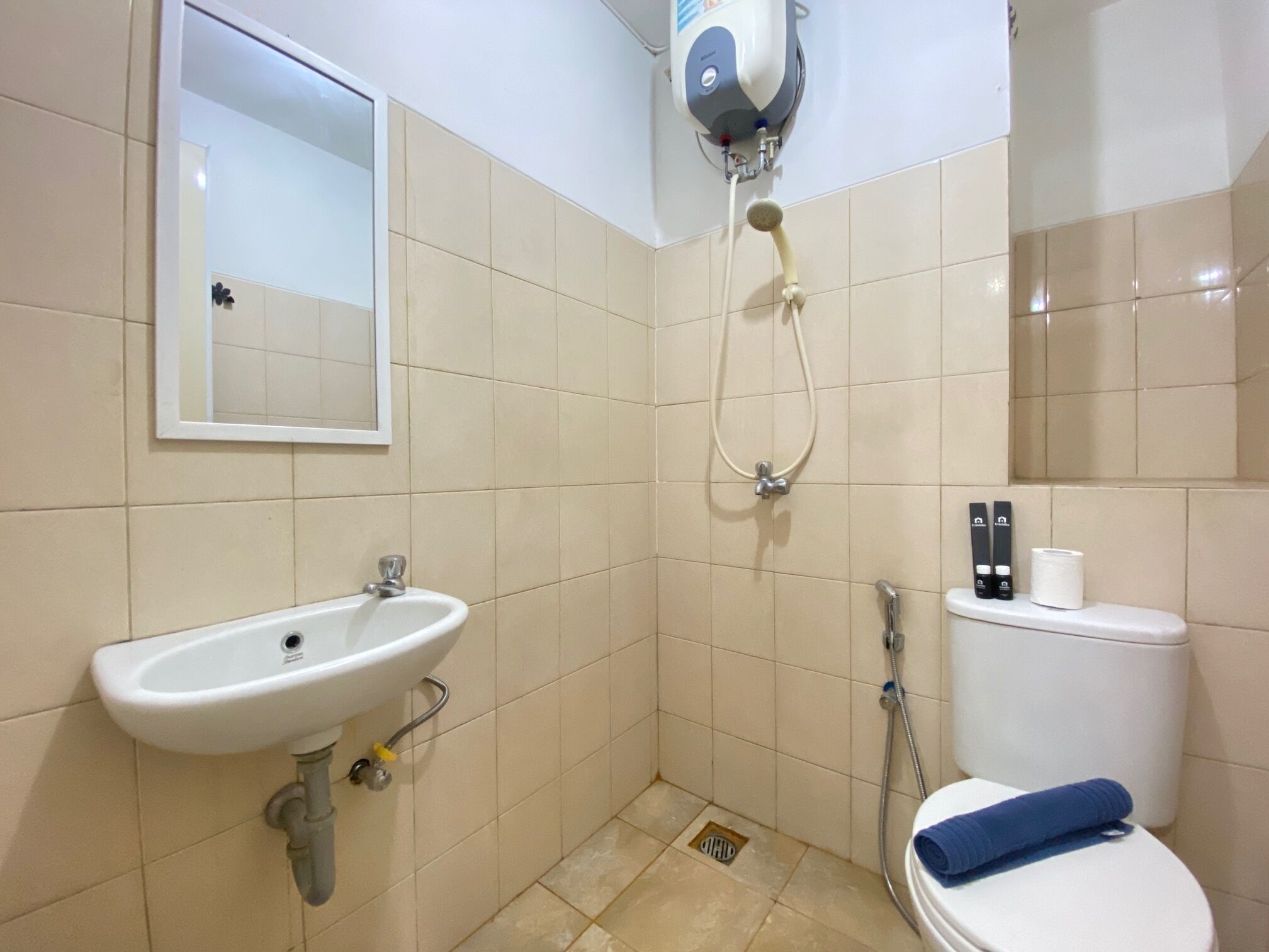 A bathroom with a sink, toilet, and shower.