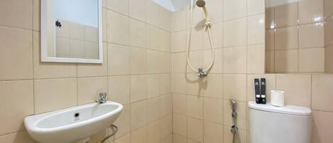 A bathroom with a sink, toilet, and shower.